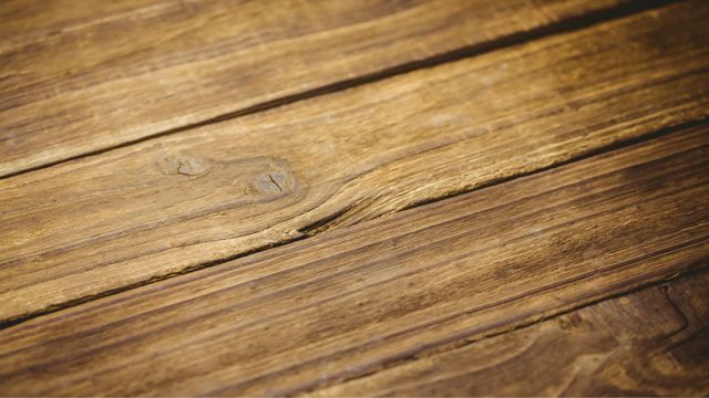 Close-up view of weathered wooden planks, featuring natural grains and a rustic appearance. This textured image is ideal for creating warm and vintage design backdrops, use in woodworking, or interior design themes. Suitable for digital projects, web design, and print materials needing natural wood textures.