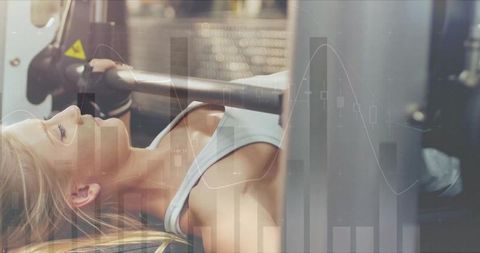 Athletic woman bench pressing with digital data overlay
