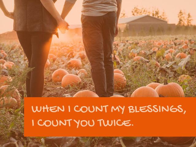 A couple holding hands in a pumpkin patch at sunset. The image has an overlay text: 'When I count my blessings, I count you twice.'. Ideal for inspirational quotes, fall wedding invitations, Thanksgiving cards, or promoting relational and love themes.