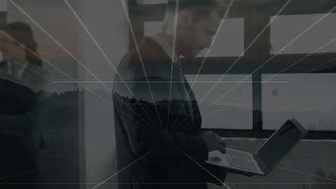 Businessman Using Laptop with Digital Interface Overlay in Office