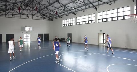High School Basketball Team Practicing in Gymnasium