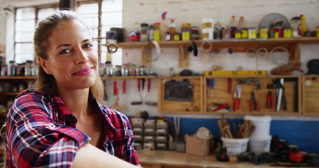 Confident Female Carpenter in Workshop Smiling with Tools in Background - Download Free Stock Images Pikwizard.com