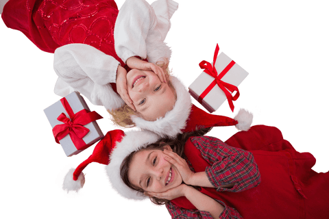 Joyful Girls in Santa Hats Lying with Gifts Over Transparent Background