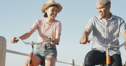 Diverse Couple Enjoying Sunny Bike Ride by the Sea - Download Free Stock Images Pikwizard.com