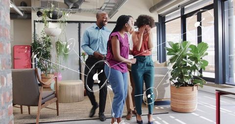 Coworkers surprising colleague in modern office lounge with plants and network overlay
