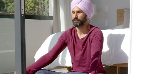 Man meditating at home for peaceful relaxation