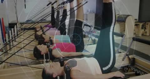 Women Exercising on Reformers with Digital Interface Animation