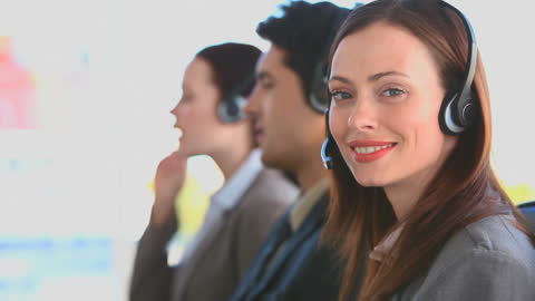 Diverse Call Center Team Assisting Customers with Headsets