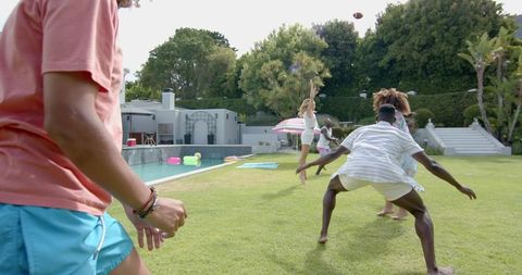 Diverse Friends Enjoy Outdoor Game in Bright Summer Day