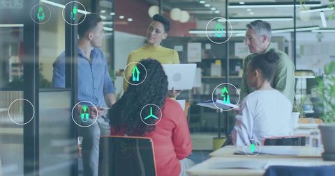 Diverse team collaborates on eco-friendly business strategy in modern office