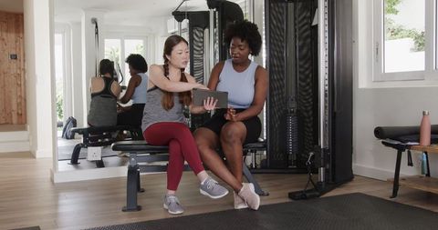 Diverse Fitness Trainer and Client Consultation at Gym