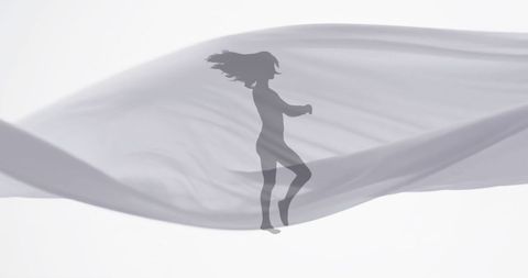 Silhouette of Dancing Woman with Floating Fabric on White Background