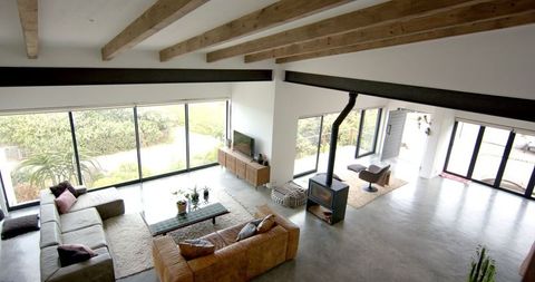 Contemporary Living Room with Wooden Beams and Large Windows