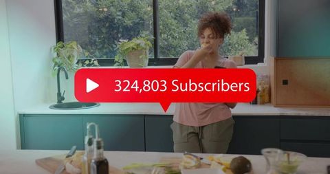Content creator eating snack in modern kitchen with 324,803 subscribers badge