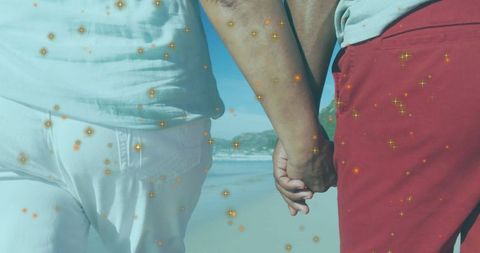 Mature Couple Strolling at Beach with Sparkling Overlay