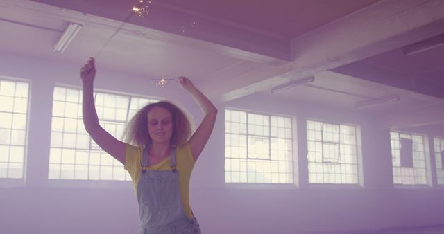 Joyful Young Woman Dancing with Sparklers in Industrial Space - Download Free Stock Images Pikwizard.com