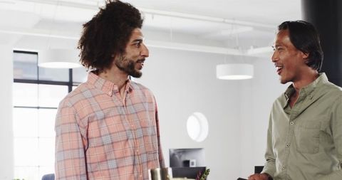 Diverse Colleagues Engaging in Positive Discussion at Modern Office