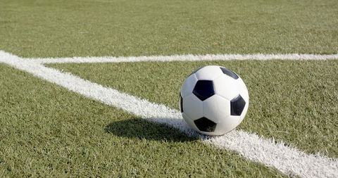 Soccer ball on field corner marking agile moment of sport
