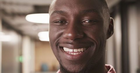 Confident Professional Man Smiling in Modern Office Setting