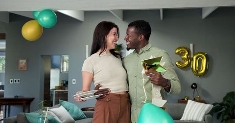 Couple Celebrating Birthday Party in Stylish Living Room