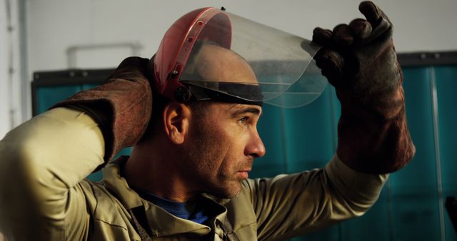 Industrial Worker Adjusting Protective Face Shield in Workshop - Download Free Stock Images Pikwizard.com