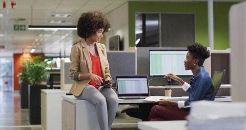 Collaborative Colleagues Reviewing Data Techniques in Modern Office