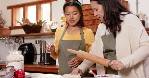 Mother and daughter bonding over holiday baking in cozy kitchen
