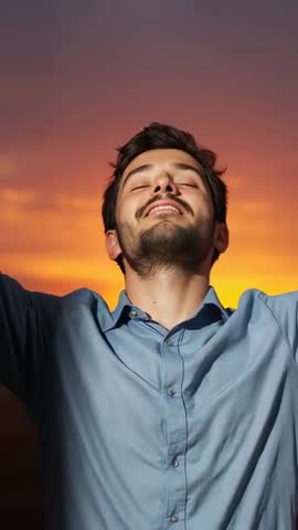 Man Lifting Head, Raising Arms at Sunset Feeling Relief and Calm | Vertical Video