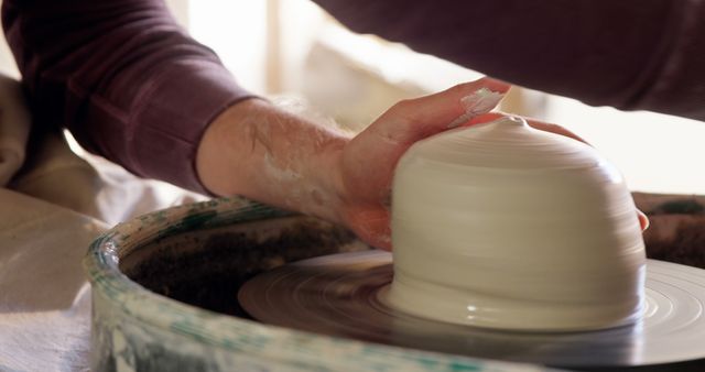 Close-Up of Hands Creating Pottery on Spinning Wheel - Download Free Stock Images Pikwizard.com