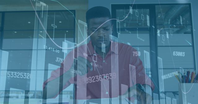 Image of financial graphs and data over african american man in office. Business, finance, economy, data processing and technology concept digitally generated image.