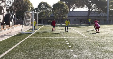Youth soccer players training on sunny field