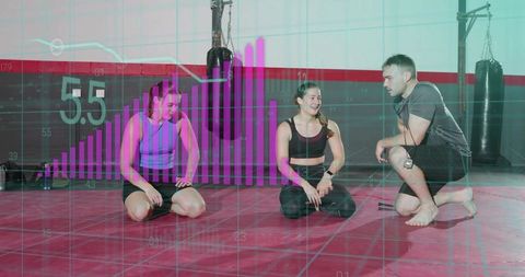 Coach guiding two trainees on red mat with fitness analytics overlay