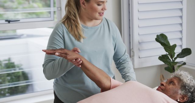 Compassionate Physiotherapist Assisting Senior Woman with Rehabilitation Exercise - Download Free Stock Images Pikwizard.com