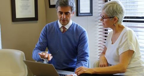 Professional consultation with businessman and senior woman in modern office