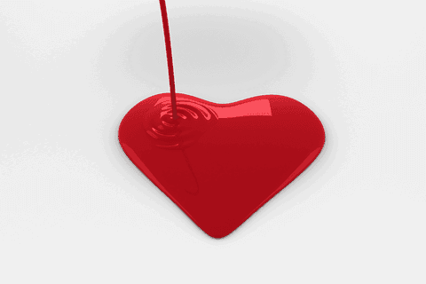 Red paint pouring into heart on transparent background