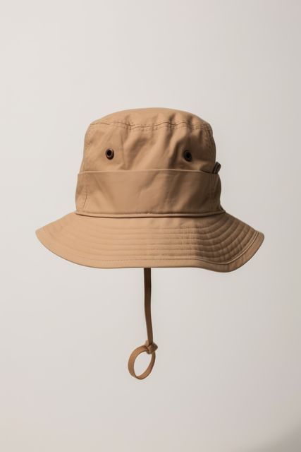 Beige bucket hat on grey background, created using generative ai technology. Fashion, hats and headwear concept digitally generated image.