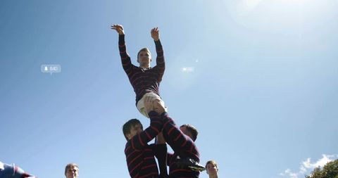Rugby Lineout Lifting Demonstrating Teamwork and Athleticism Under Clear Blue Sky