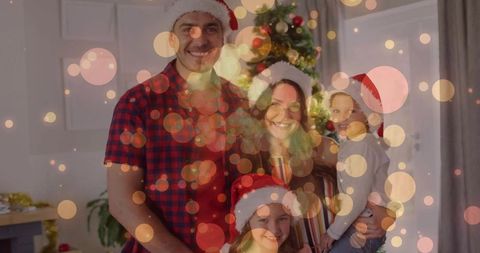 Joyful Family Celebrating Christmas with Santa Hats