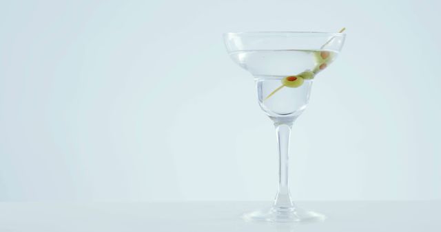 Martini cocktail glass with olives garnish on white background - Download Free Stock Images Pikwizard.com