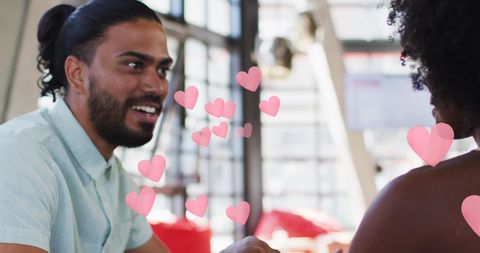 Romantic couple holding hands in bright restaurant
