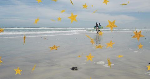 Walking surfers carrying surfboards on reflective beach with gold star overlay