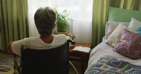 Senior Woman in Wheelchair Reflecting in Cozy Living Space
