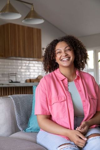 Smiling woman relaxing in stylish open-plan living area