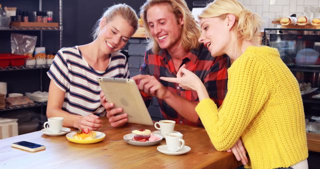 Friends Enjoying Coffee and Pastries in a Cozy Café - Download Free Stock Images Pikwizard.com