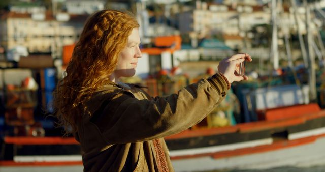 Red-haired Woman Taking Photo by Harbor at Sunset - Download Free Stock Images Pikwizard.com