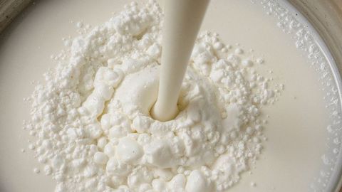 Pouring creamy liquid with rich texture for culinary preparations