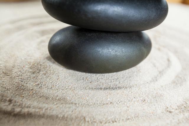 Stack of pebble stones on a sand