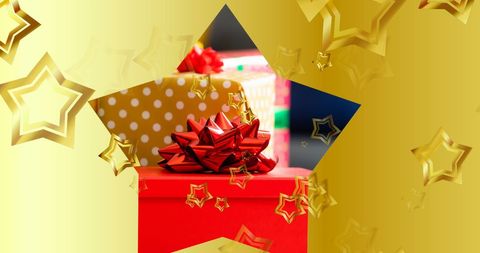 Golden stars over christmas gift with red bow