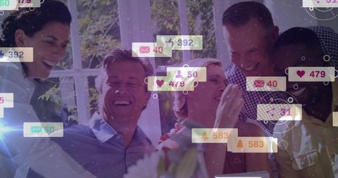 Friends Laughing Around Table Showing Social Media Notifications and Engagement Overlays
