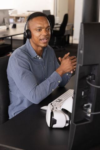 Professional Conducting Virtual Meeting with VR Headset in Office